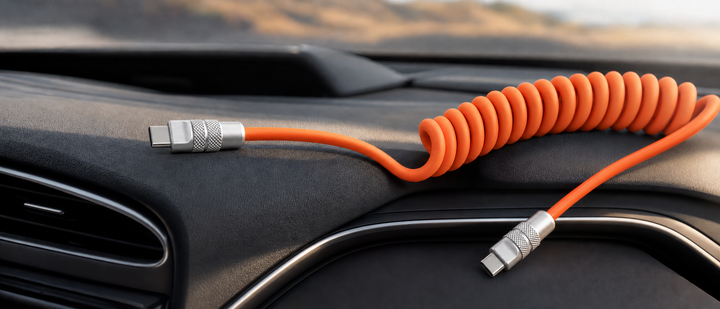 A coiled orange Chubby USB-C cable on a car dashboard.