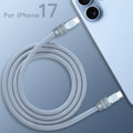 Top view of coiled blue-grey 240W silicone fast charging cable with anodized connectors, product shot. C to C